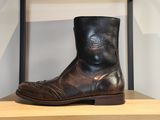 des bottes en cuir posées sur une étagère dans une pièce aux murs blancs