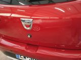 a close up of a red car with a badge on it
