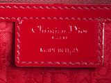 a close up of a red purse with a tag on it