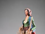 figurine of a woman with a basket of wheat in her hand
