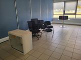 an empty room with chairs and a desk in it