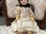a doll that is sitting on a chair in a room