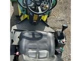 a tractor that is sitting on the ground with a steering wheel