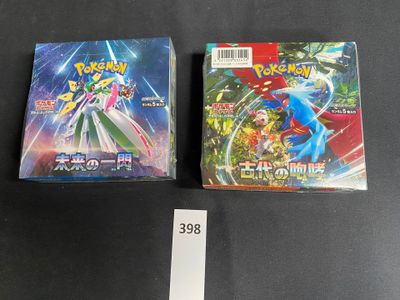 two boxes of pokemon trading cards on a table with a price tag