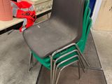 a green chair and a black chair in a room