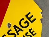 a yellow and red sign that says usage under it