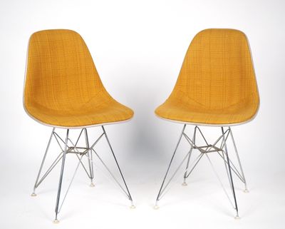 une paire de chaises jaunes aux pieds chromés sur fond blanc