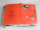 an open book with a picture of a pair of scissors on it