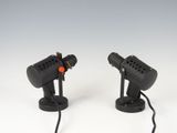 a pair of black microphones sitting on top of each other
