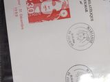 two envelopes with stamps on them sitting on a table