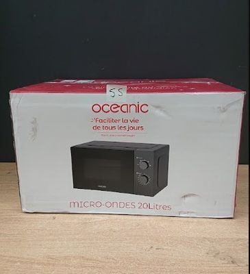 packaging of a microwave sitting on top of a wooden table