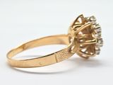 an image of a gold ring with a diamond center