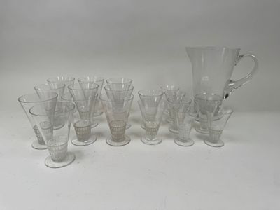 a lot of glasses and a pitcher on the table