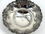 an antique silver plate with a horse on it on a white surface