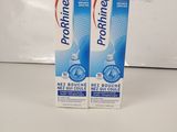 two boxes of toothpaste sitting on top of a counter