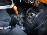 a car dashboard with a steering wheel and a wooden shift handle
