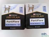 two boxes of proplan cat food sitting on top of a white table