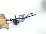a toy of a bull pulling a cart with a cart attached to it