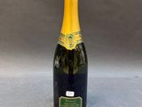 a bottle of champagne sitting on top of a table