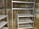 three shelves in the corner of a room with a tile floor