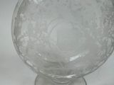 a clear glass vase with a floral design on it