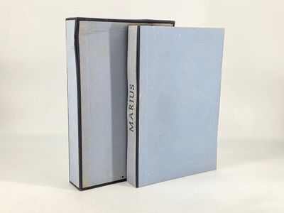 a pair of books sitting on top of each other on a white surface