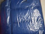 two pieces of luggage wrapped in plastic on a table