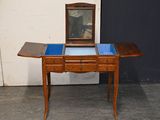 a small wooden table with a mirror on top of it