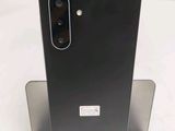 a close up of the back of a black phone on a stand