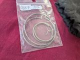 a bag of silver rings sitting on a red cloth