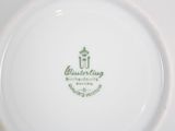 a close up of a white plate with a green logo on it