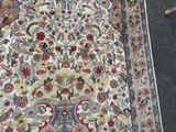 a large rug on the floor with a cat laying on it