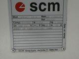 a picture of a sign on a wall that says scm