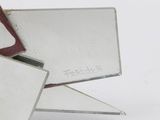 a pair of scissors sitting on top of a piece of glass