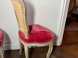 two chairs sitting next to each other on a wooden floor