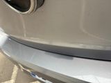 a close up of a car ' s exhaust pipe on the front of the car