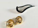a pair of earrings that are sitting on a table