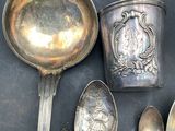 a lot of silver spoons and spoons on a table