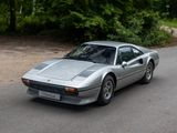 a silver sports car driving down the road