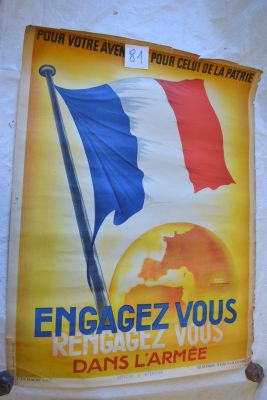 posters on the wall of a building with a french flag on it