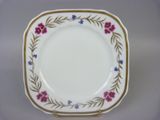 a white plate with pink and blue flowers on it