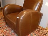 brown leather recliner in a living room with an oriental rug