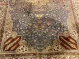 a large blue rug on the floor in a room