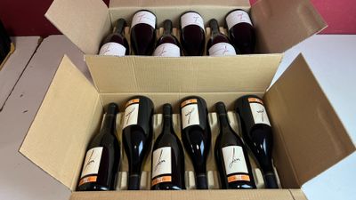 plusieurs bouteilles de vin dans une caisse sur la table