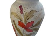 un vase blanc orné de fleurs rouges et jaunes
