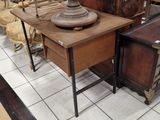 a table with a lamp on top of it in the middle of a room