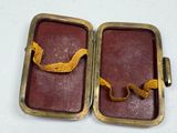 two brown leather cases with a yellow ribbon in them
