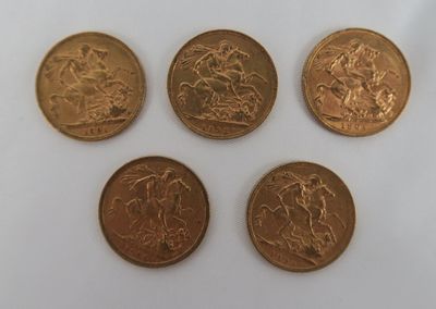 four different types of gold coins on a white surface
