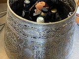 bottles of beer in a metal container on a counter