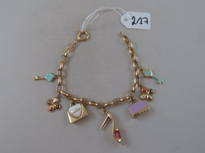 a close up of a gold bracelet with charms on it